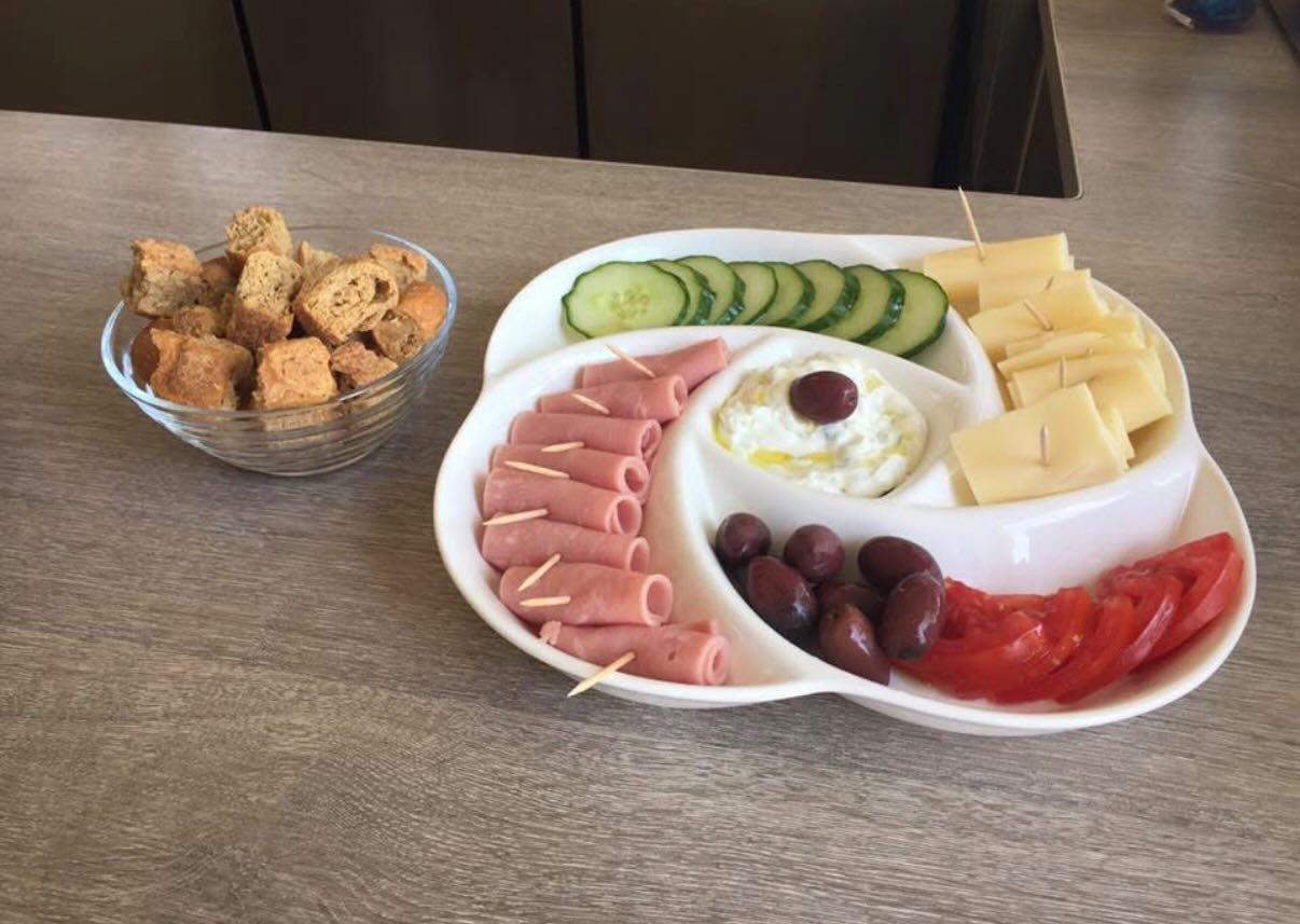 Traditional Cretan breakfast platter with cheese, olives, tomato, cucumber and rusks